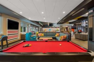 a billiard room with a red pool table at Tru By Hilton Wilson in Wilson