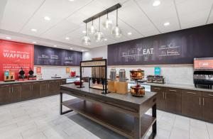 a fast food restaurant with a counter with food at Hampton Inn Albertville, Al in Albertville