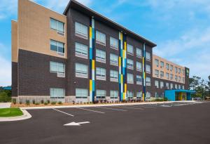 an office building with a parking lot at Tru By Hilton Novi Detroit in Novi