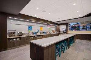 a fast food restaurant with a counter and stools at Tru By Hilton Destin in Destin