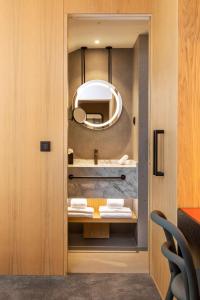 a bathroom with a sink and a mirror at Arts Hotel Porto, Tapestry Collection By Hilton in Porto