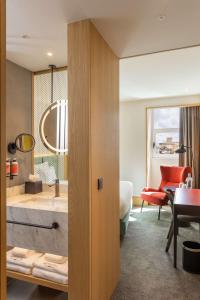 a hotel room with a bathroom with a sink at Arts Hotel Porto, Tapestry Collection By Hilton in Porto