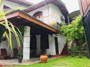 an external view of a house with a patio at Surewo Apartment in Bentota