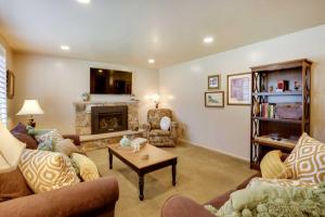 a living room with two couches and a fireplace at Updated Ranch Apartment with Deck - 9 Mi to Downtown in Taylorsville