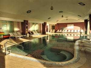 a large swimming pool in a hotel room at Yes Hotel Touring & SPA in Rimini
