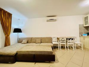 a bedroom with a bed and a dining room at Altheda Living Tiny House in Suceava