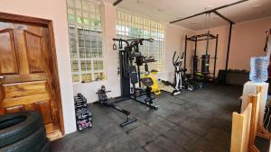 a gym with treadmills and bikes in a room at Ace House in Nyeri