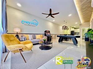 a living room with a couch and a table at The Apple Residence By Heystay Management in Melaka