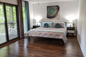 a bedroom with a bed and a balcony at Lakeside Trail in Bella Vista