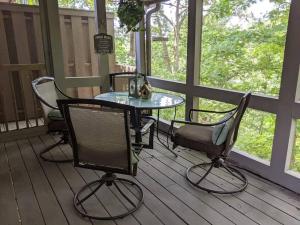 a table and chairs on a screened in porch at Lakeside Trail in Bella Vista