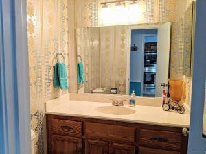 a bathroom with a sink and a large mirror at Lakeside Trail in Bella Vista +23 photos