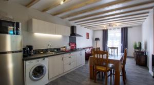 a kitchen and dining room with a table and a dining room at Gîte Chez Pierrot - La vallée des châteaux in La Roque-Gageac