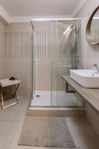 a bathroom with a glass shower and a sink at REVON Business apartment Senec in Senec +14 photos