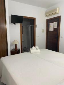 Posteľ alebo postele v izbe v ubytovaní Hostal Casa López