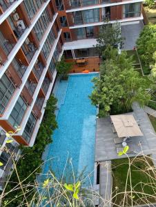an overhead view of a swimming pool in a building at Tierra Residences in Bangkok