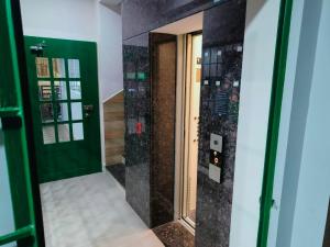 a bathroom with a shower with a mirror at Alohaa Homestel in Coimbatore