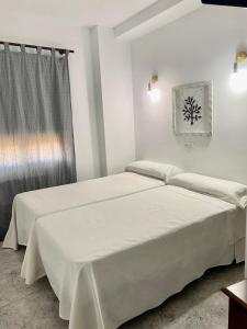 Posteľ alebo postele v izbe v ubytovaní Hostal Casa López