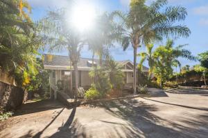 a house with palm trees on a street at Pu'ukala Sunset Estate with Amazing Ocean Views! home in Kailua-Kona