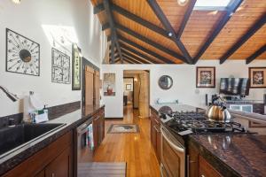 a kitchen with wooden counters and a stove top oven at Pu'ukala Sunset Estate with Amazing Ocean Views! home in Kailua-Kona