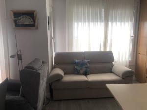 uma sala de estar com um sofá e uma cadeira em ENMAYO 2021 - Dos alojamientos em Córdoba