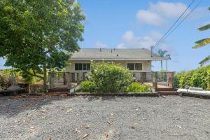 a house with a large driveway in front of it at Charming Pu'ukala Sunset - Near Hiking and Golf home in Kailua-Kona