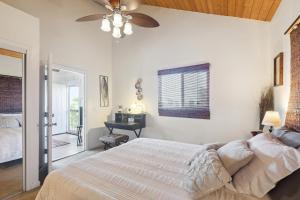 a bedroom with a bed and a ceiling fan at Charming Pu'ukala Sunset - Near Hiking and Golf home in Kailua-Kona +6 photos