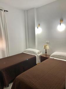 Posteľ alebo postele v izbe v ubytovaní Hostal Casa López