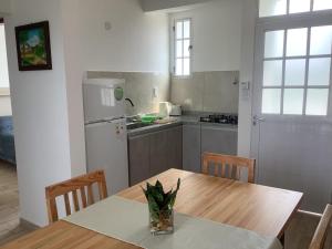 a kitchen with a wooden table and a table and chairs at Los Olivos in Federación