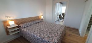 a bedroom with a bed with a wooden headboard at Balcón Playa Delicias in Águilas