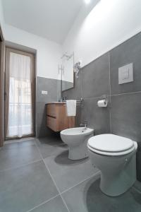 a bathroom with a toilet and a sink at Cerchia Apartments in Corbara