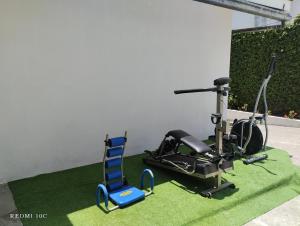 a gym with a treadmill and a blue chair at The Dream House in Quito