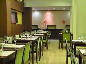 a dining room with tables and chairs with wine glasses at Grand Hotel in Reconquista