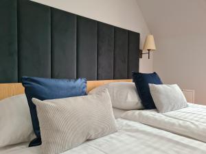 a bedroom with two beds with blue and white pillows at Ski Hotel in Piwniczna-Zdrój