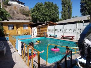 a group of people in a swimming pool at Hostel San Felipe in San Felipe
