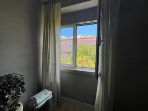 a window with a curtain in a room at Casa do João • City Break • Lisbon in Lisbon