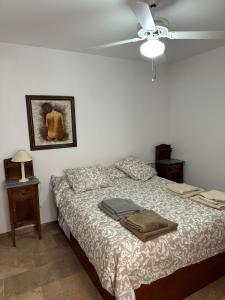 a bedroom with a bed and a ceiling fan at Aguadulce Primera Línea - A/C in Aguadulce