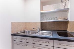 a kitchen with a sink and a counter at Cozy 1BR4P apartment with balcony - IenaTrocadero in Paris