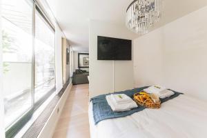a bedroom with a bed and a large window at Cozy 1BR4P apartment with balcony - IenaTrocadero in Paris