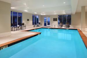 a large swimming pool with blue water in a building at Candlewood Suites - Lebanon, an IHG Hotel in Lebanon