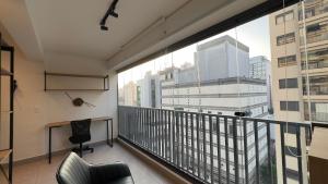 an office with a balcony with a view of the city at Apartamento na paulista (com garagem) in Sao Paulo