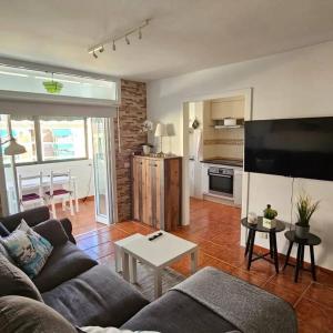 a living room with a couch and a table at Apartman Los Cristianos-Cristimar in Los Cristianos