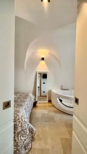 a bathroom with a tub and a sink and a bath tub at Greta’s suite & private spa in Perinaldo