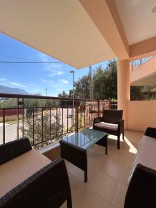 a balcony with a table and chairs and a view at Feel at home - Kalamata - Near the center in Kalamata