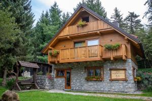 a log cabin with a balcony on top of it at Vacation house Kula in Jasenak
