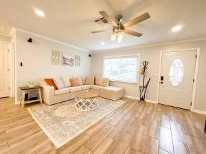 a living room with a couch and a ceiling fan at Tropical Backyard Paradise, Hot Tub, Fenced yard in Lakeland