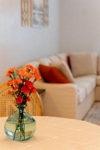 a vase with orange flowers sitting on a table at Tropical Backyard Paradise, Hot Tub, Fenced yard in Lakeland +18 photos