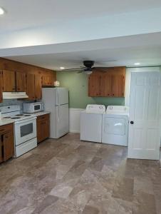 a kitchen with white appliances and wooden cabinets at Canobie Lake 3bedroom waterfront in Windham