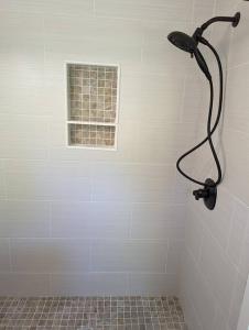 a shower in a white bathroom with a window at Canobie Lake 3bedroom waterfront in Windham
