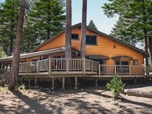 a large wooden house with a porch in the woods at Family Haven in Graeagle CA w/King Bed Suite in Graeagle