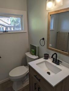 a bathroom with a toilet and a sink and a mirror at Canobie Lake 3bedroom waterfront in Windham